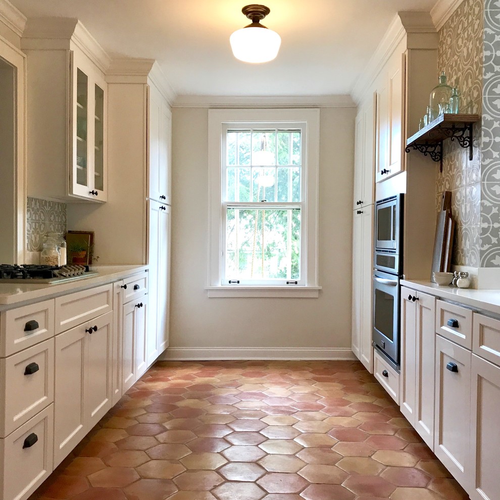 Kitchen - small craftsman galley terra-cotta tile kitchen idea in Baltimore with an undermount sink, shaker cabinets, white cabinets, granite countertops, cement tile backsplash, stainless steel appliances and a peninsula