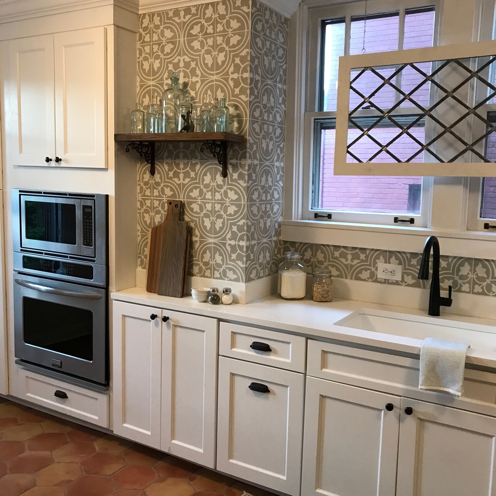 Example of a small arts and crafts galley terra-cotta tile kitchen design in Baltimore with an undermount sink, shaker cabinets, white cabinets, granite countertops, cement tile backsplash, stainless steel appliances and a peninsula