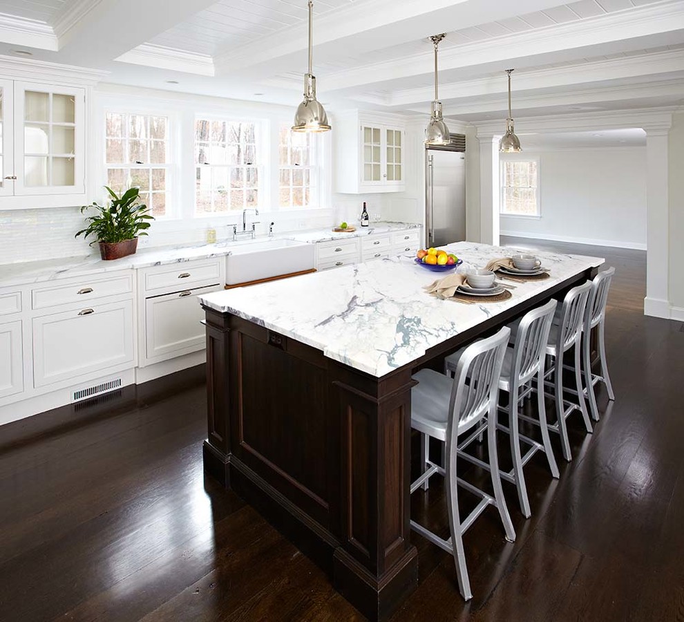 Example of a transitional eat-in kitchen design in New York with a farmhouse sink, beaded inset cabinets, white cabinets, marble countertops, multicolored backsplash and stainless steel appliances