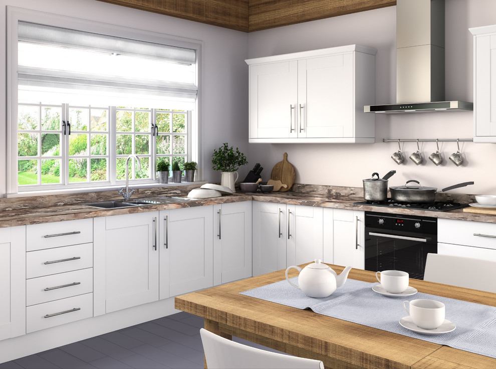 Design ideas for a medium sized contemporary l-shaped enclosed kitchen in West Midlands with white cabinets, laminate countertops, integrated appliances, no island and shaker cabinets.