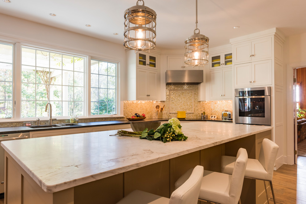 Large elegant light wood floor eat-in kitchen photo in Miami with an undermount sink, shaker cabinets, white cabinets, quartzite countertops, multicolored backsplash, mosaic tile backsplash, stainless steel appliances, an island and white countertops