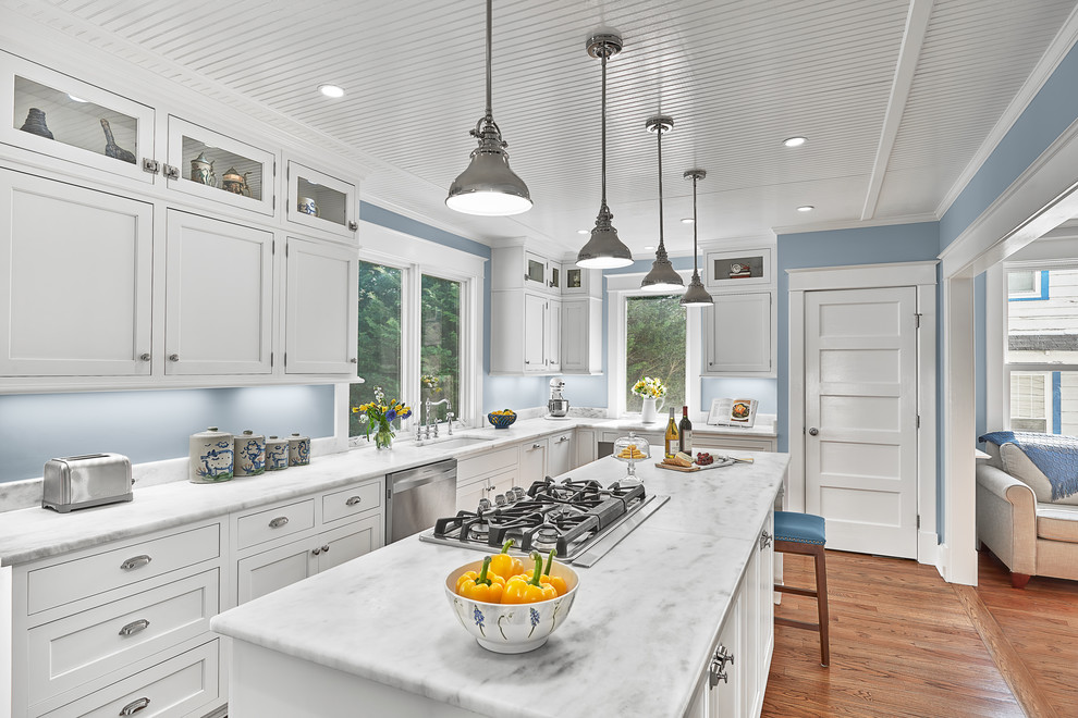 Large elegant u-shaped medium tone wood floor kitchen photo in DC Metro with an undermount sink, shaker cabinets, white cabinets, marble countertops, blue backsplash, stainless steel appliances and an island