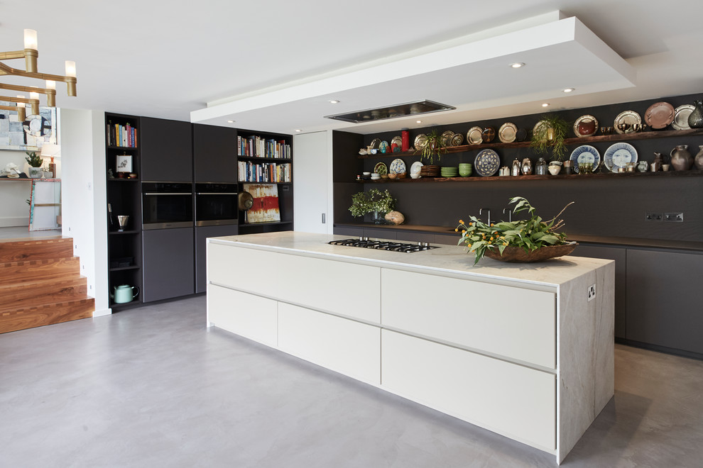 Design ideas for a large eclectic l-shaped open plan kitchen in London with flat-panel cabinets, quartz worktops, concrete flooring, an island, grey floors, beige worktops and grey cabinets.