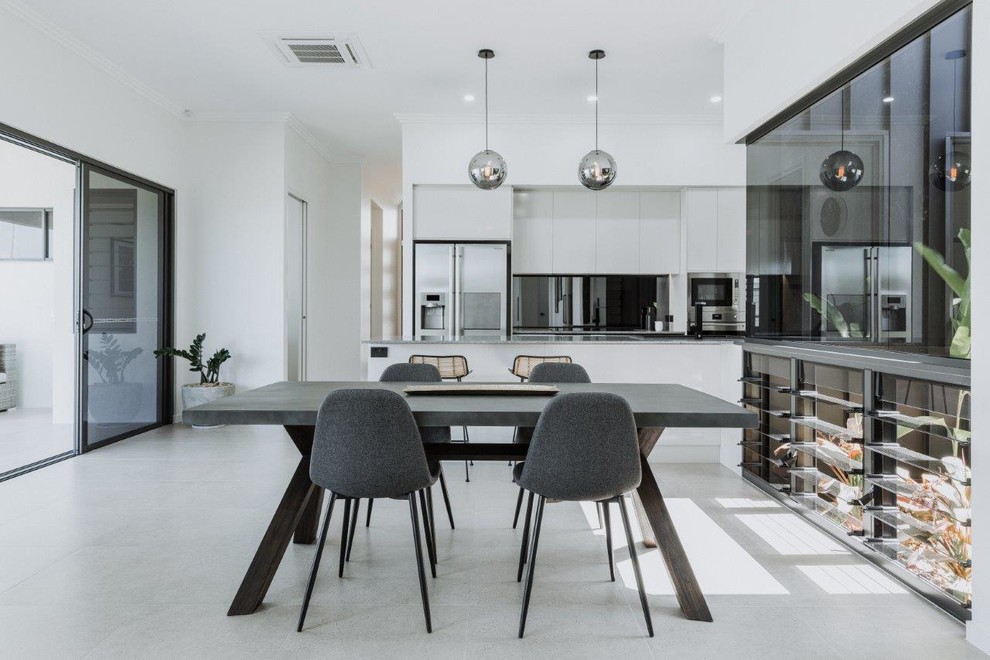 Inspiration for a mid-sized contemporary galley porcelain tile and beige floor open concept kitchen remodel in Townsville with an undermount sink, flat-panel cabinets, gray cabinets, quartz countertops, metallic backsplash, mirror backsplash, stainless steel appliances, an island and gray countertops