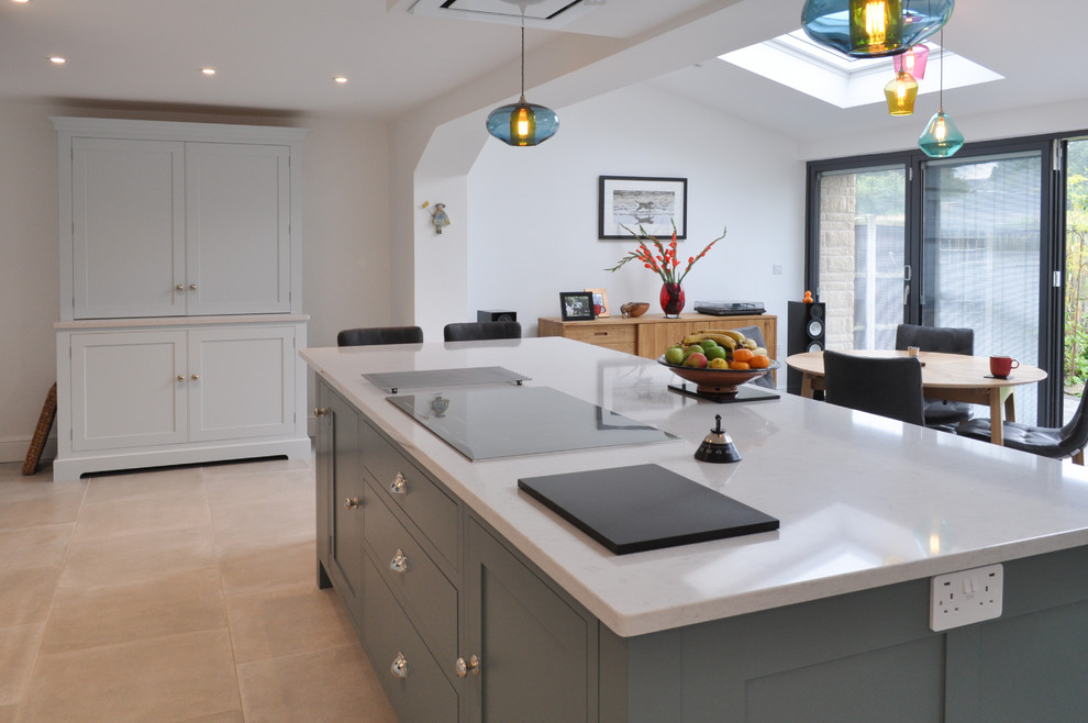 Inspiration for a large contemporary l-shaped open plan kitchen in Other with a submerged sink, shaker cabinets, blue cabinets, quartz worktops, stainless steel appliances, limestone flooring, an island and grey floors.
