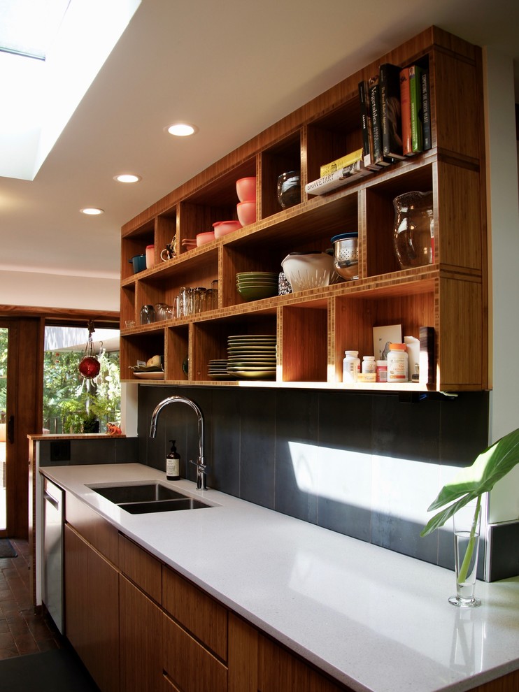 Small trendy l-shaped brick floor and red floor eat-in kitchen photo in Raleigh with an undermount sink, flat-panel cabinets, medium tone wood cabinets, quartz countertops, gray backsplash, ceramic backsplash, stainless steel appliances, no island and white countertops