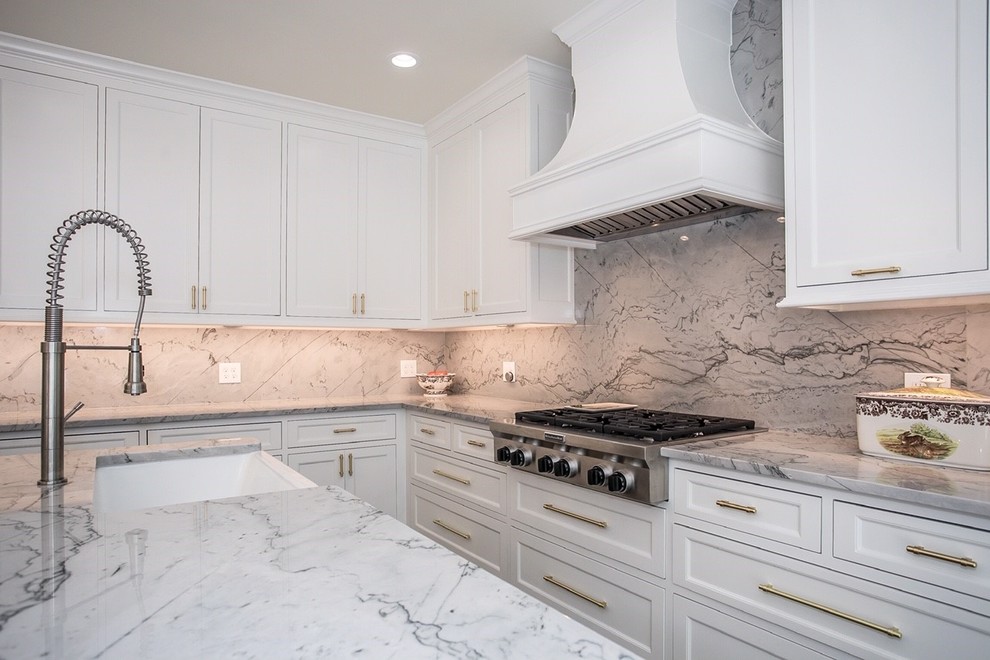 Large trendy l-shaped kitchen photo in Dallas with white cabinets, quartzite countertops, white backsplash, stone slab backsplash, two islands and white countertops