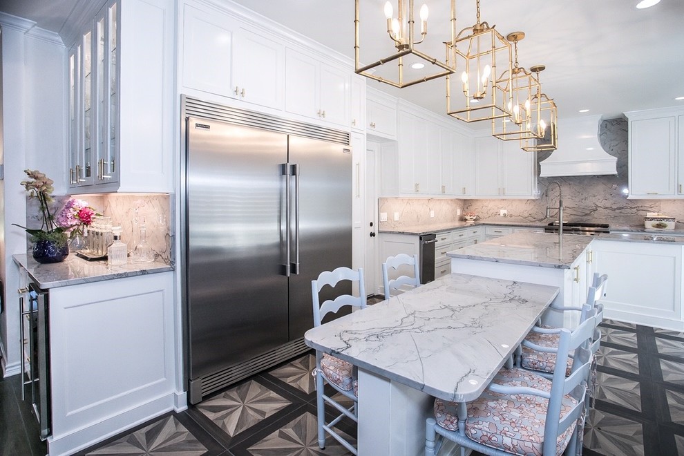 Example of a large trendy l-shaped kitchen design in Dallas with white cabinets, quartzite countertops, white backsplash, stone slab backsplash, two islands and white countertops