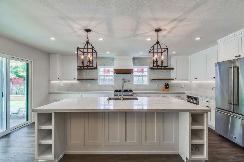 Inspiration for a mid-sized contemporary u-shaped porcelain tile and brown floor eat-in kitchen remodel in Orange County with an undermount sink, recessed-panel cabinets, white cabinets, quartz countertops, white backsplash, stone slab backsplash, stainless steel appliances, an island and white countertops