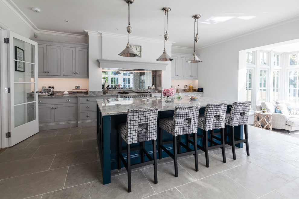 Photo of a medium sized classic single-wall kitchen in Essex with a submerged sink, grey cabinets, marble worktops, mirror splashback, stainless steel appliances, an island, grey floors and shaker cabinets.