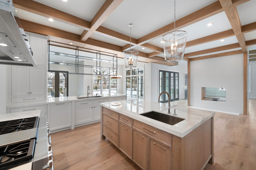Eat-in kitchen - huge transitional u-shaped light wood floor and beige floor eat-in kitchen idea in Chicago with an undermount sink, flat-panel cabinets, white cabinets, quartz countertops, white backsplash, stone slab backsplash, paneled appliances, an island and white countertops