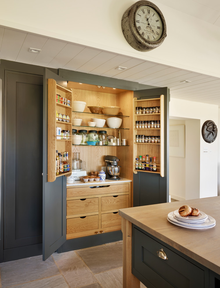 Design ideas for a large traditional kitchen pantry in Essex with grey cabinets, wood worktops and an island.