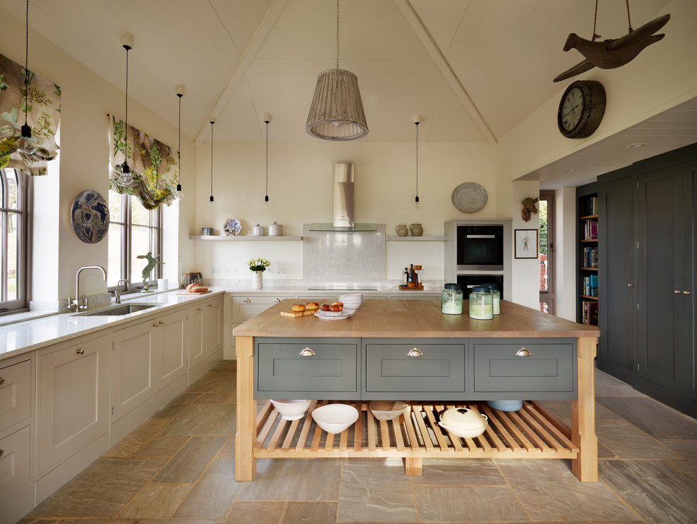 Large rural grey and cream l-shaped kitchen in Essex with grey cabinets, wood worktops, an island, a submerged sink and shaker cabinets.