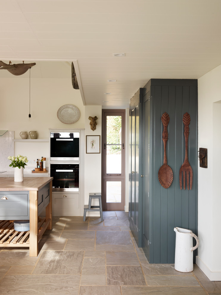 Open concept kitchen - large coastal l-shaped open concept kitchen idea in Essex with gray cabinets, wood countertops and an island