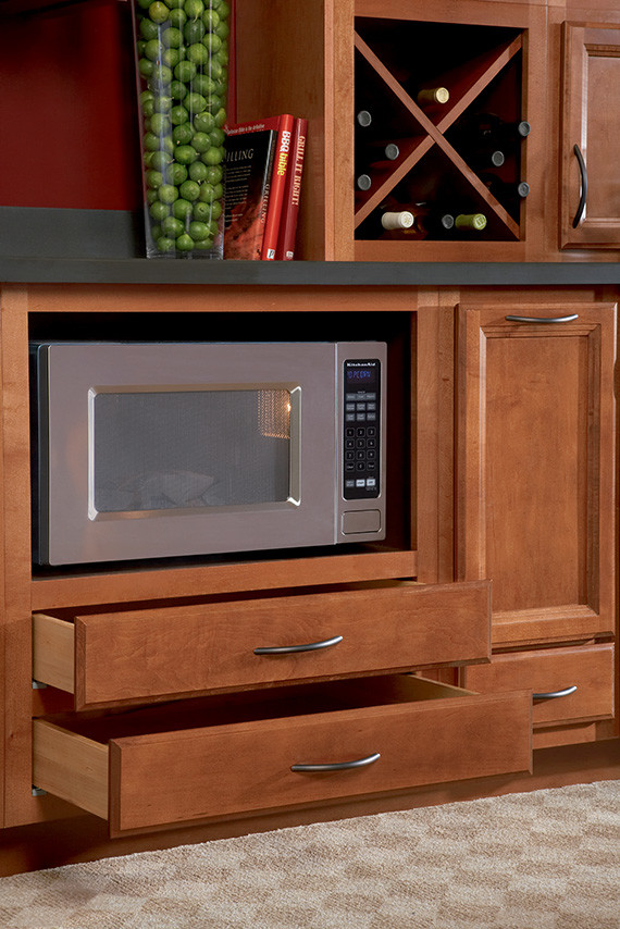 Photo of a kitchen/diner in DC Metro with recessed-panel cabinets, composite countertops and carpet.