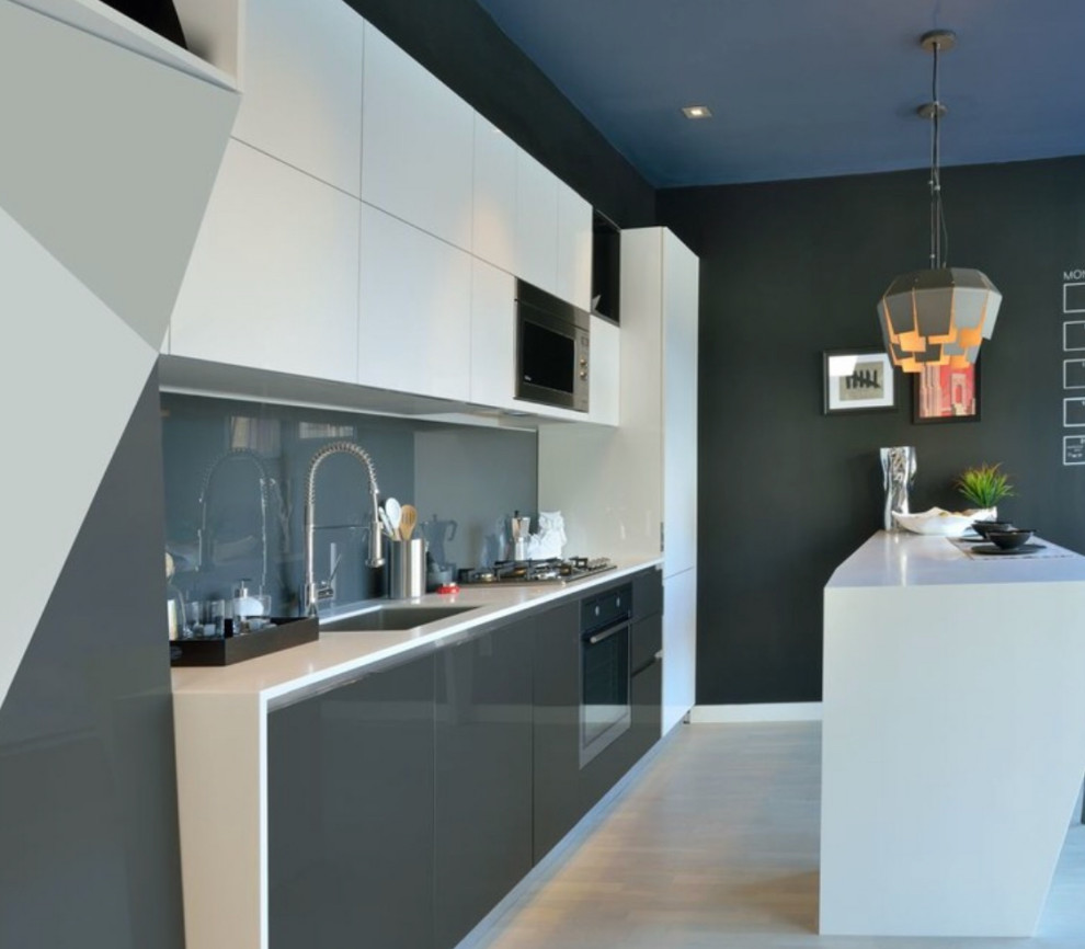 Small modern single-wall open plan kitchen in Toronto with flat-panel cabinets, white cabinets, an island and white worktops.