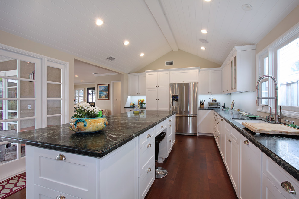 Large traditional l-shaped enclosed kitchen in Orange County with a built-in sink, shaker cabinets, white cabinets, soapstone worktops, stainless steel appliances, dark hardwood flooring and an island.