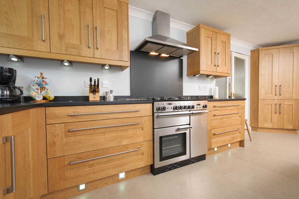This is an example of a large classic kitchen/diner in Other with light wood cabinets, granite worktops, black splashback, stainless steel appliances, lino flooring and an island.