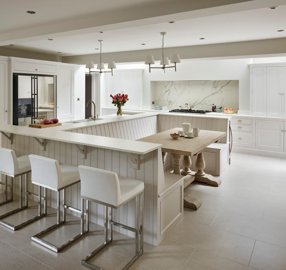 This is an example of a modern open plan kitchen in Other with stainless steel appliances, an island and white worktops.
