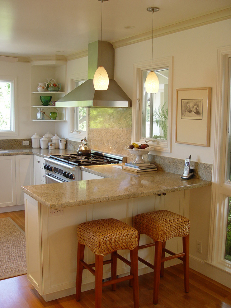 Elegant kitchen photo in San Francisco with stainless steel appliances, granite countertops and stone slab backsplash