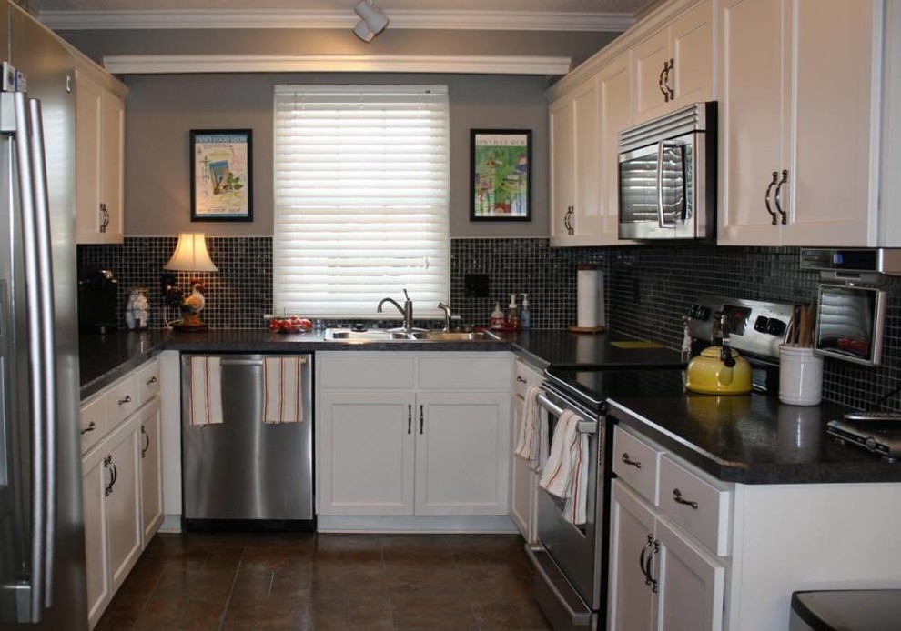 This is an example of a medium sized classic kitchen in Orlando with a double-bowl sink, shaker cabinets, white cabinets, laminate countertops, black splashback, stainless steel appliances and ceramic flooring.