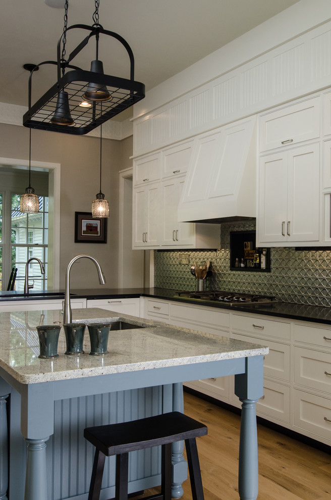 Example of a large country u-shaped light wood floor eat-in kitchen design in DC Metro with a farmhouse sink, recessed-panel cabinets, white cabinets, granite countertops, gray backsplash, metal backsplash, stainless steel appliances and an island