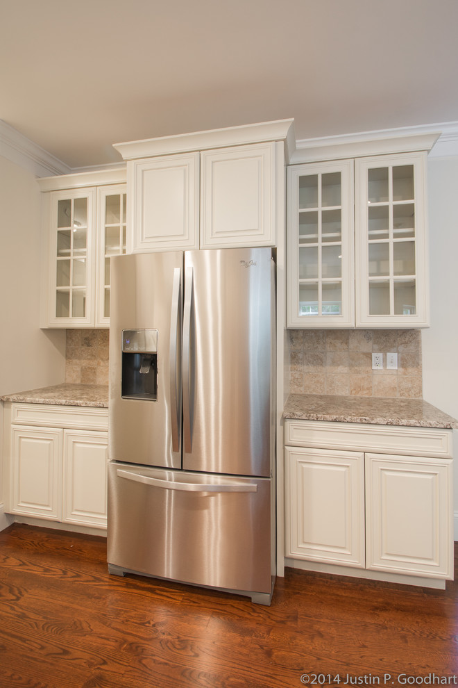 Photo of a classic kitchen in Philadelphia with beige splashback, stainless steel appliances, medium hardwood flooring and an island.
