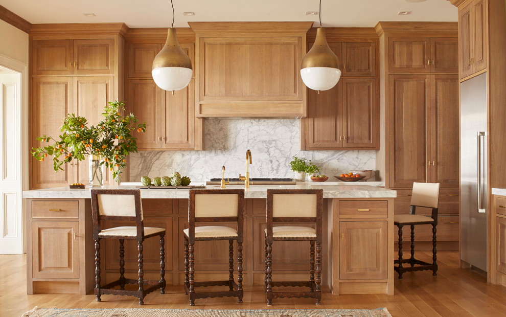 Example of a large classic galley light wood floor eat-in kitchen design in Jacksonville with an undermount sink, raised-panel cabinets, marble countertops, white backsplash, stone slab backsplash, stainless steel appliances, an island and light wood cabinets