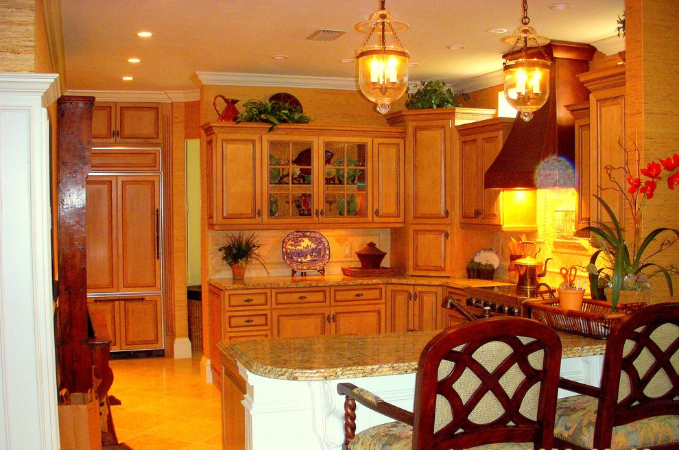 Medium sized traditional u-shaped kitchen in Miami with a belfast sink, raised-panel cabinets, distressed cabinets, granite worktops, beige splashback, travertine splashback, limestone flooring and no island.