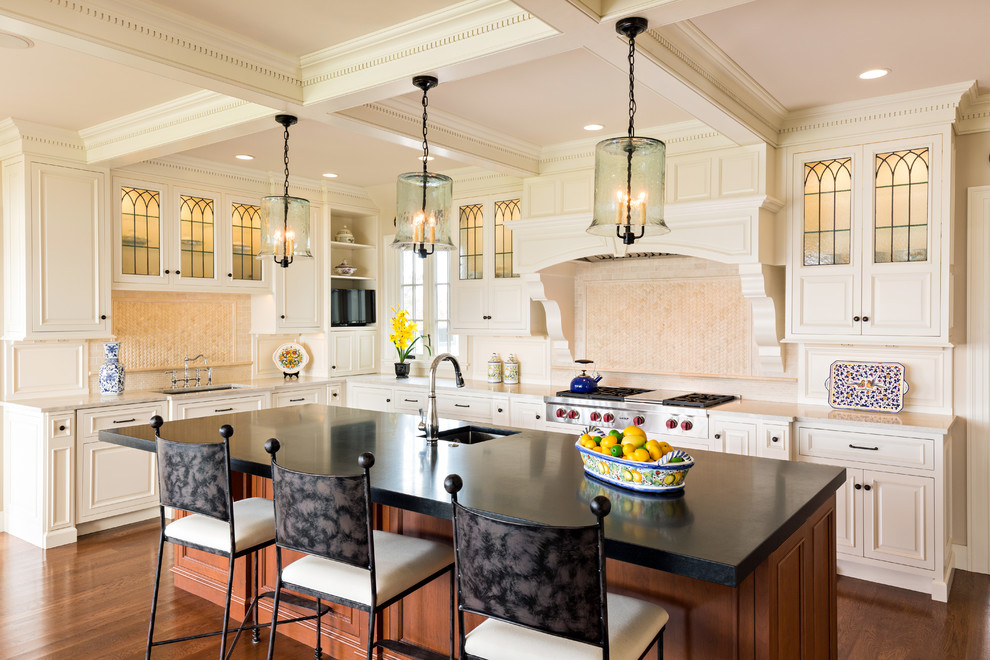 This is an example of a large traditional u-shaped kitchen/diner in Boston with a submerged sink, raised-panel cabinets, white cabinets, stainless steel appliances, dark hardwood flooring, an island, soapstone worktops, white splashback and ceramic splashback.