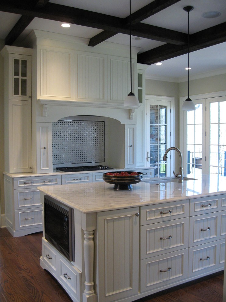 Design ideas for a farmhouse kitchen in Other with beaded cabinets, white cabinets, marble worktops, dark hardwood flooring and an island.