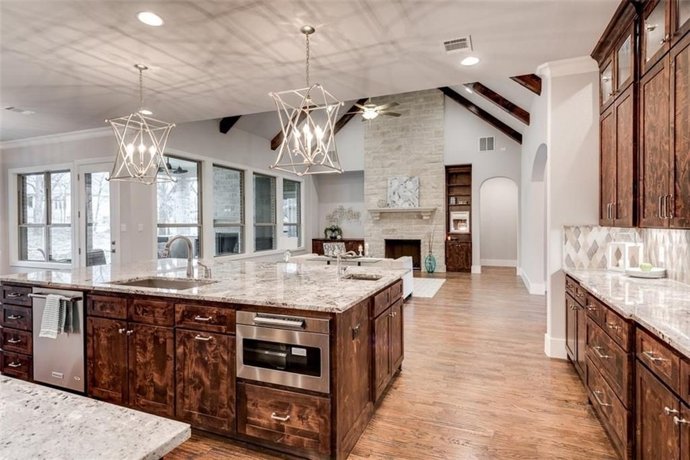 Inspiration for a modern l-shaped medium tone wood floor and brown floor open concept kitchen remodel in Dallas with an undermount sink, shaker cabinets, medium tone wood cabinets, granite countertops, multicolored backsplash, glass tile backsplash, stainless steel appliances and an island