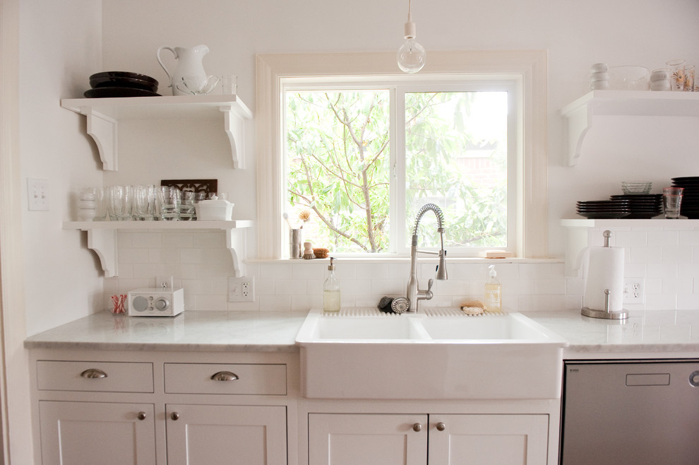 Inspiration for a timeless kitchen remodel in Dallas with subway tile backsplash, a drop-in sink, open cabinets, white cabinets, marble countertops and white backsplash