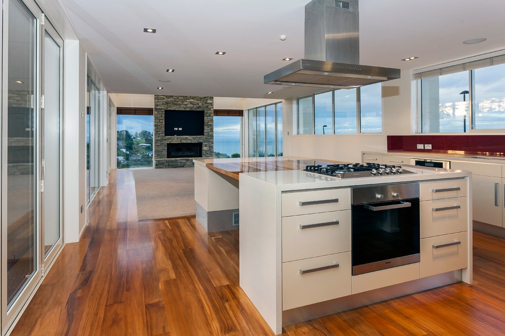 Offene, Zweizeilige, Geräumige Moderne Küche mit Granit-Arbeitsplatte, Küchengeräten aus Edelstahl, braunem Holzboden und zwei Kücheninseln in Christchurch