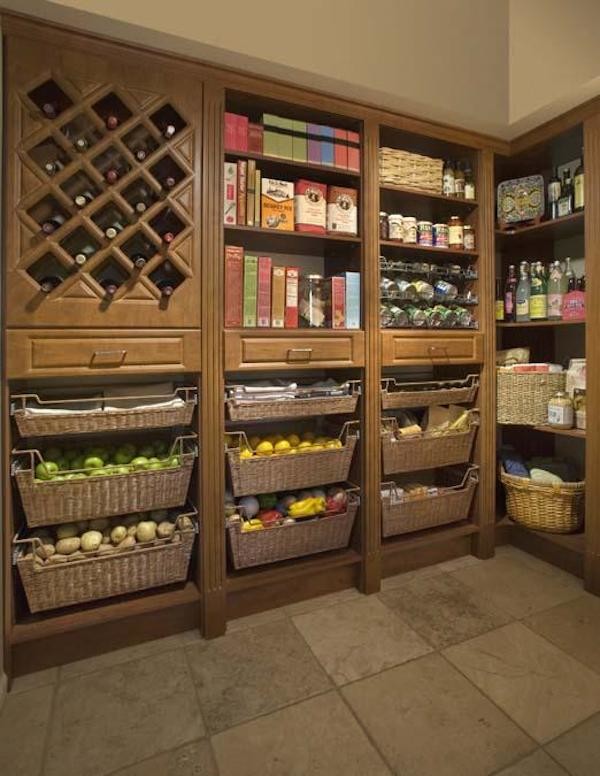 Large u-shaped kitchen pantry in Phoenix with medium wood cabinets and slate flooring.