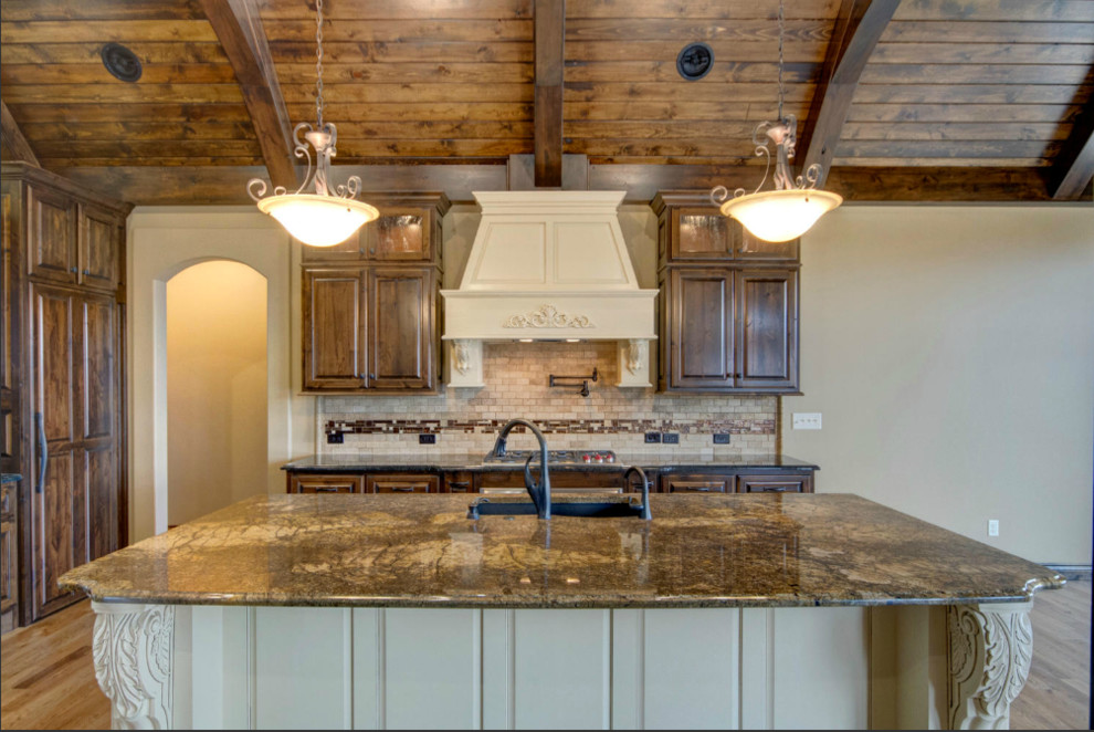 Large mountain style galley light wood floor eat-in kitchen photo in Wichita with an undermount sink, raised-panel cabinets, light wood cabinets, granite countertops, beige backsplash, stone tile backsplash, paneled appliances and an island