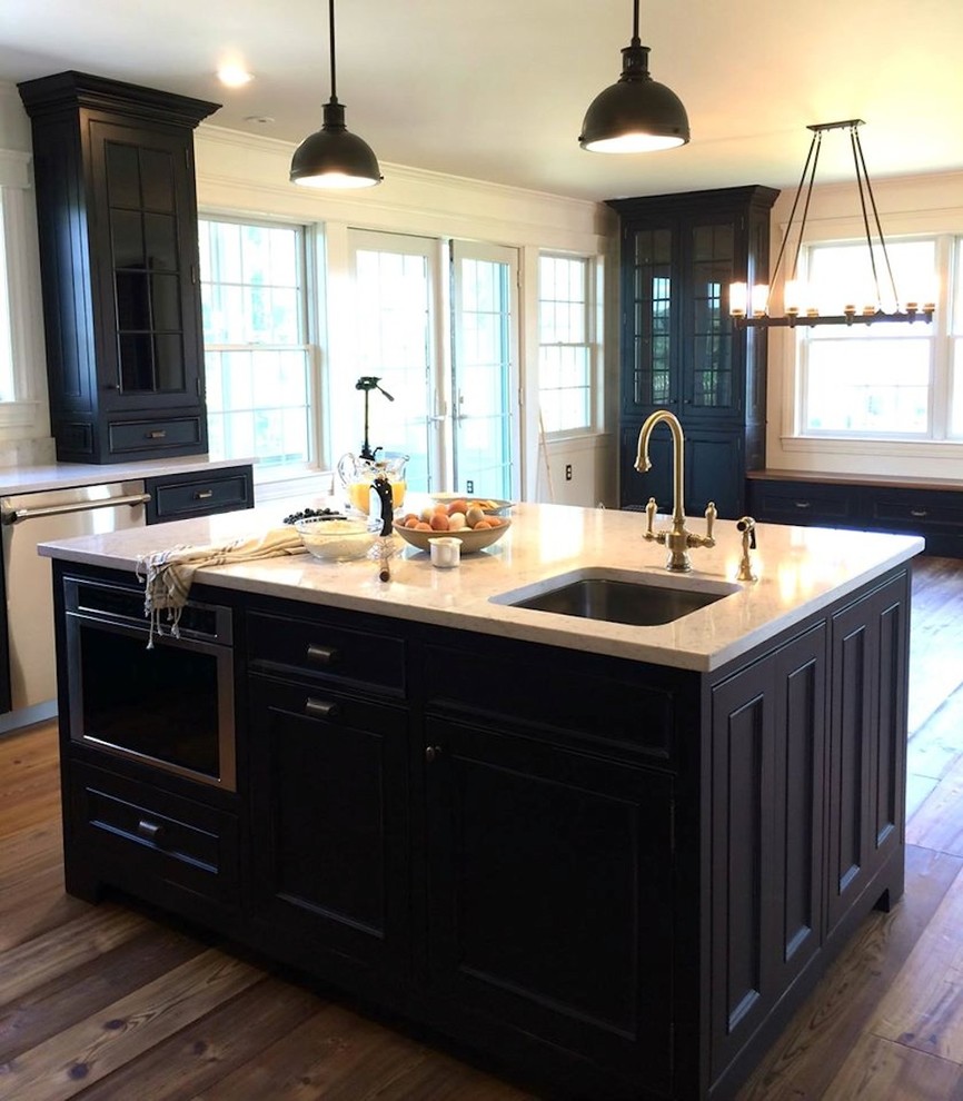 Inspiration for a mid-sized timeless l-shaped medium tone wood floor eat-in kitchen remodel in New York with an undermount sink, recessed-panel cabinets, black cabinets, quartz countertops, stainless steel appliances and an island