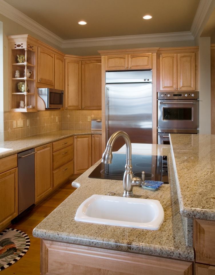 Inspiration for a large traditional galley enclosed kitchen in Seattle with a double-bowl sink, raised-panel cabinets, light wood cabinets, granite worktops, beige splashback, stainless steel appliances, medium hardwood flooring and an island.
