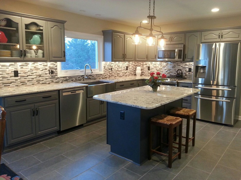 Example of a large classic l-shaped linoleum floor eat-in kitchen design in Philadelphia with a farmhouse sink, beaded inset cabinets, gray cabinets, granite countertops, gray backsplash, glass tile backsplash, stainless steel appliances and an island