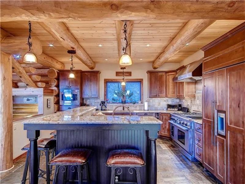 Inspiration for a mid-sized southwestern kitchen remodel in Denver with recessed-panel cabinets, medium tone wood cabinets, gray backsplash, stainless steel appliances and an island