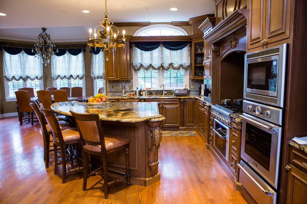 Mid-sized elegant u-shaped dark wood floor and brown floor eat-in kitchen photo in Philadelphia with a double-bowl sink, recessed-panel cabinets, dark wood cabinets, granite countertops, metallic backsplash, glass tile backsplash, an island and stainless steel appliances
