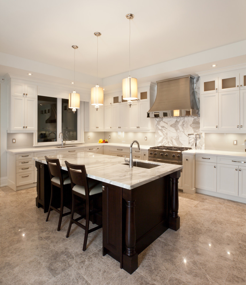 Foto på ett mellanstort funkis kök, med en undermonterad diskho, skåp i shakerstil, vita skåp, bänkskiva i kvarts, vitt stänkskydd, stänkskydd i stenkakel, rostfria vitvaror, kalkstensgolv och en köksö