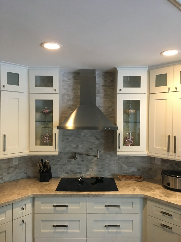 Inspiration for a medium sized contemporary l-shaped open plan kitchen in Miami with shaker cabinets, white cabinets, composite countertops, multi-coloured splashback, stone tiled splashback, stainless steel appliances, light hardwood flooring and beige floors.