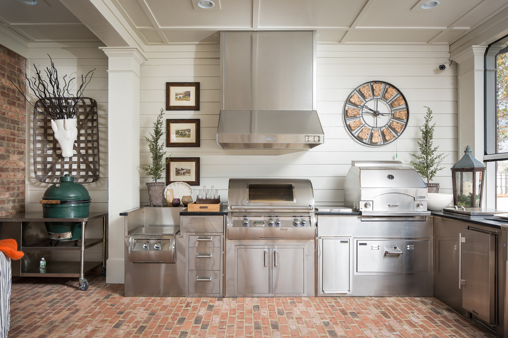 アトランタにあるトラディショナルスタイルのおしゃれなキッチン (ステンレスキャビネット、ステンレスカウンター、白いキッチンパネル、シルバーの調理設備、レンガの床、アイランドなし) の写真