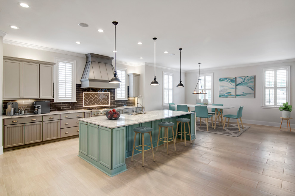 Example of a large cottage single-wall porcelain tile and brown floor open concept kitchen design in Jacksonville with a farmhouse sink, gray cabinets, quartz countertops, brown backsplash, stainless steel appliances, an island, white countertops, recessed-panel cabinets and subway tile backsplash