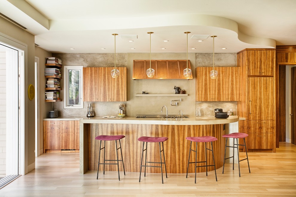 Mid-sized trendy single-wall light wood floor and brown floor kitchen photo in San Francisco with gray backsplash, flat-panel cabinets, brown cabinets, an island, a drop-in sink, marble countertops and paneled appliances