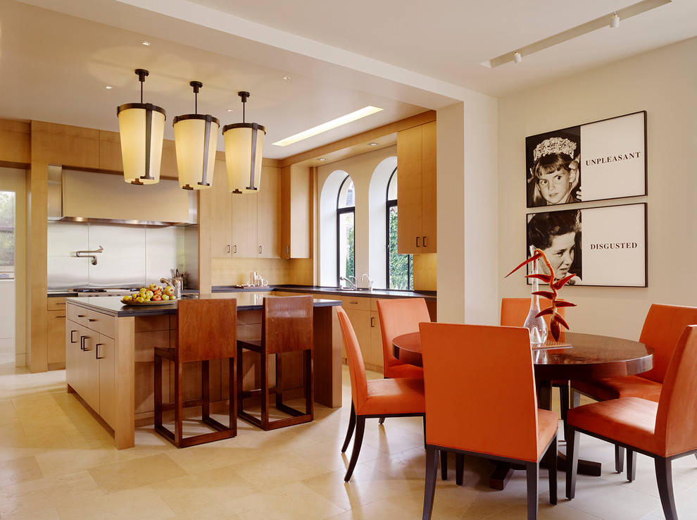Example of a trendy eat-in kitchen design in San Francisco with flat-panel cabinets, light wood cabinets, beige backsplash and stainless steel appliances