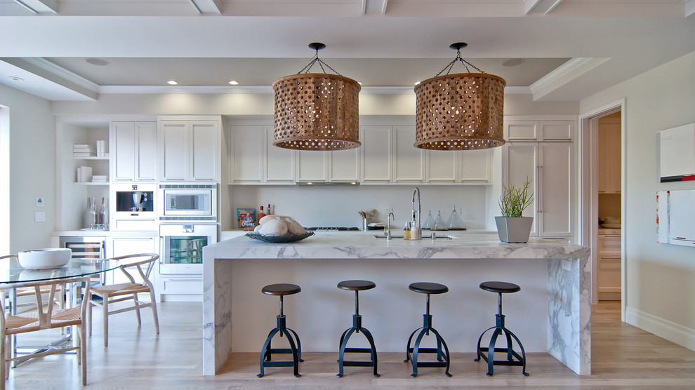 Inspiration for a traditional galley kitchen/diner in San Francisco with a submerged sink, recessed-panel cabinets, white cabinets and integrated appliances.