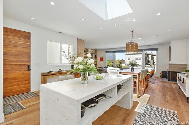 Foto di una piccola cucina minimal con parquet chiaro, ante lisce, ante bianche, top in marmo e pavimento beige
