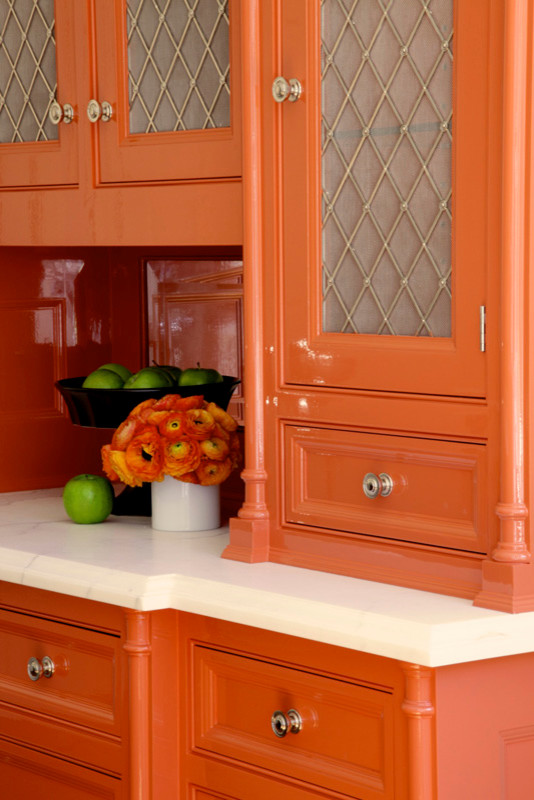 Exemple d'une cuisine tendance avec des portes de placard oranges.